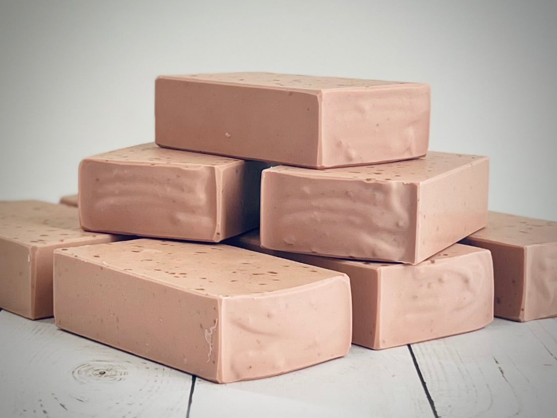 Batch_93 Cranberry, Stack of brown soap bars on a wooden surface with a neutral background