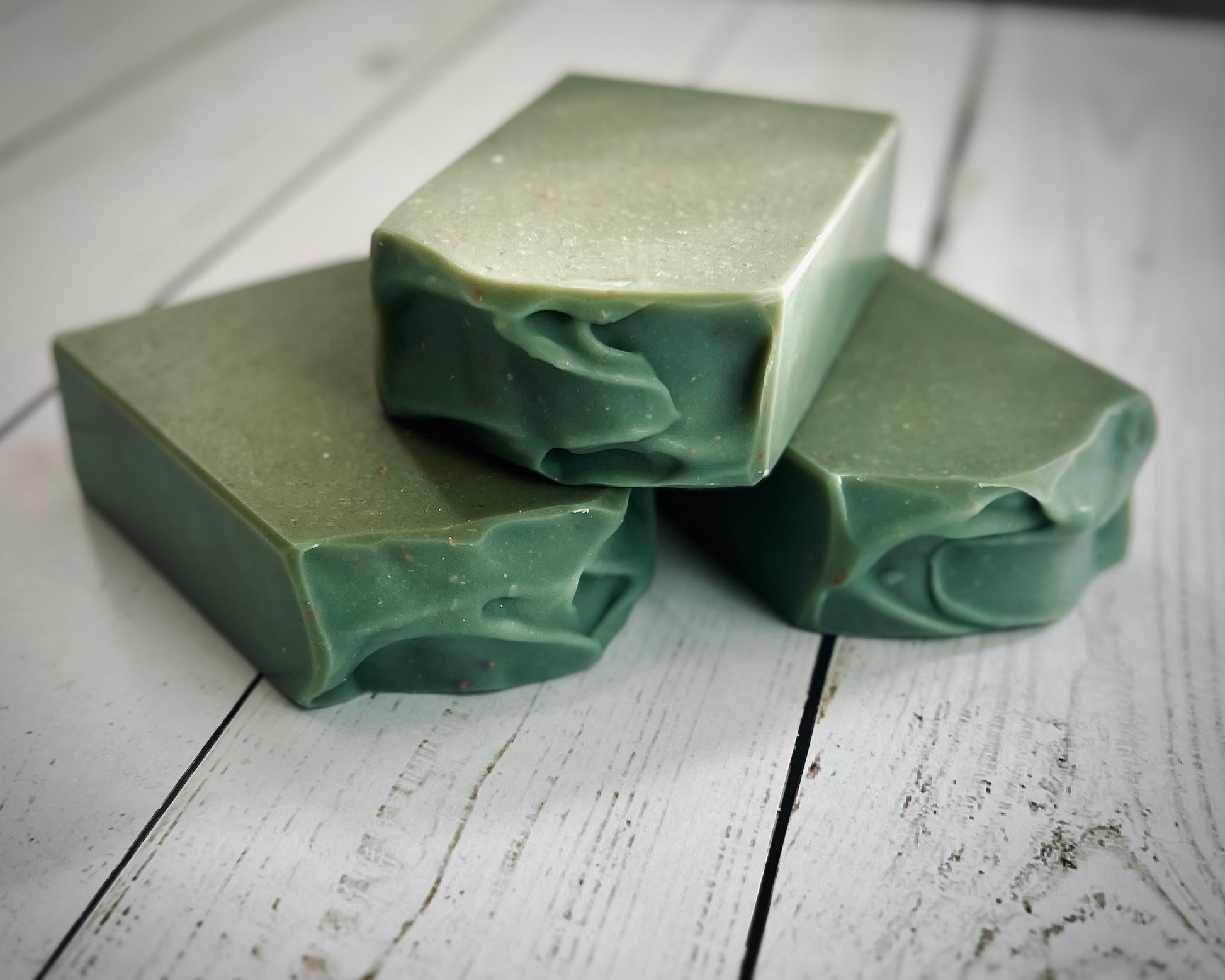 Batch 96 Mint and Eucalyptus, Three green bars of soap on a white wooden surface
